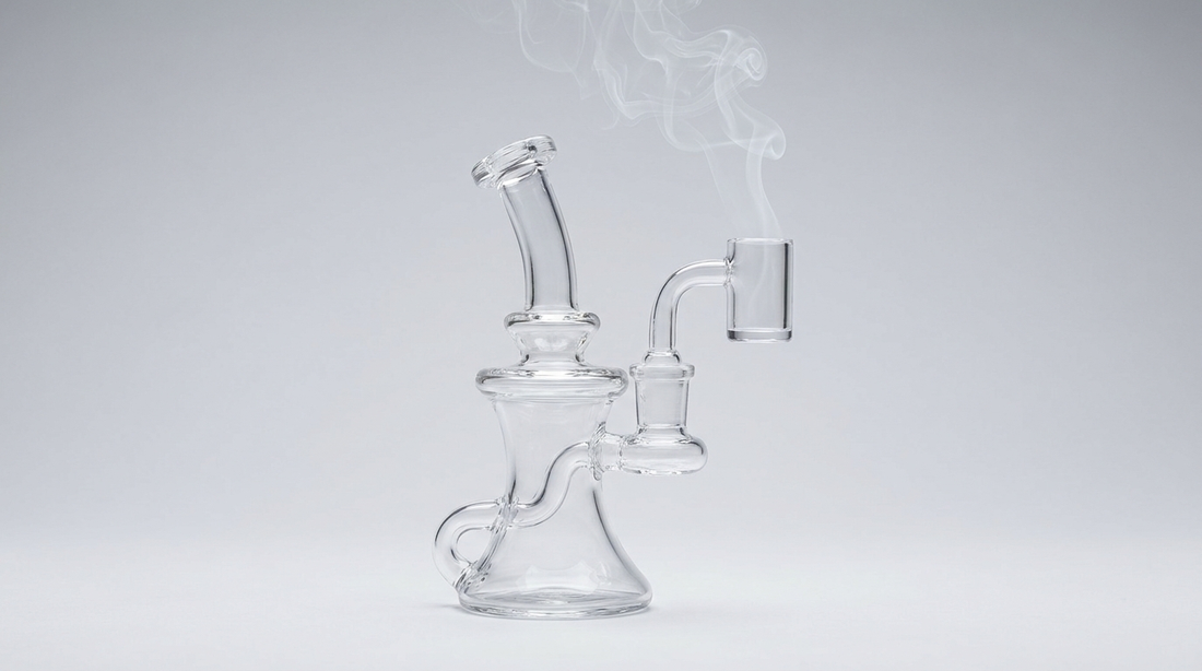 Clear glass dab rig with a quartz banger and light vapor