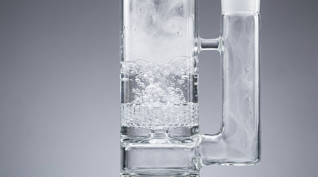 Clear glass percolator bong diffusing smoke into water through a honeycomb perc