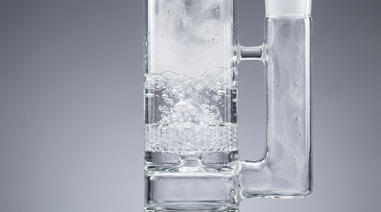 Clear glass percolator bong diffusing smoke into water through a honeycomb perc